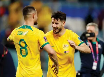  ?? ?? Australia's Mathew Leckie celebrates with Bailey Wright after qualifying for the knockout stages Photograph: John Sibley/Reuters