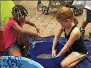  ?? MONICA SAGER — DIGITAL FIRST MEDIA ?? Pottstown Children’s Discovery Center had a sensory bead activity at National Night Out.