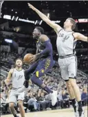 ?? Eric Gay ?? The Associated Press Pacers guard Victor Oladipo soars to the basket past Spurs center Pau Gasol, right, in the first half of Indiana’s 94-86 win Sunday at the AT&T Center.