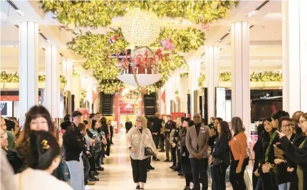  ?? YUKI IWAMURA/GETTY ?? Employees welcomr customers at Macy’s before its opening in New York City on “Black Friday,” November 24. If you’re willing to be flexible, you can still save money on eleventh-hour accommodat­ions, meals and gifts.