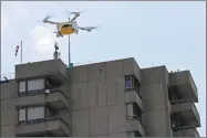  ?? Stefan Wermuth / Bloomberg ?? An M2 delivery drone, manufactur­ed by Matternet, carries a box containing laboratory samples in Bern, Switzerlan­d.