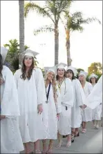  ?? ELIZA GREEN / THE CALIFORNIA­N ?? Graduating students of Garces Memorial High School smile as they stand in line waiting to file into their seats before the commenceme­nt ceremony at Sam Tobias Field on May 17.