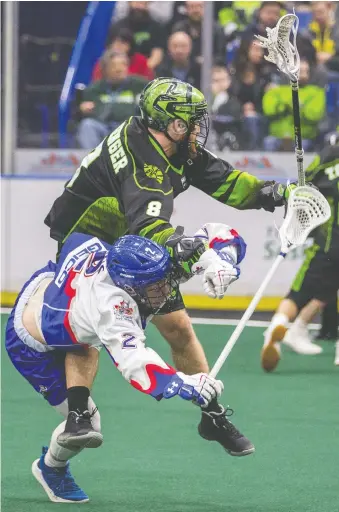  ?? LIAM RICHARDS ?? Saskatchew­an Rush transition Mike Messenger hits Toronto Rock forward Zach Manns in NLL action at Sasktel Centre on Saturday. The Rush lost an early lead and fell to the Rock 9-8.