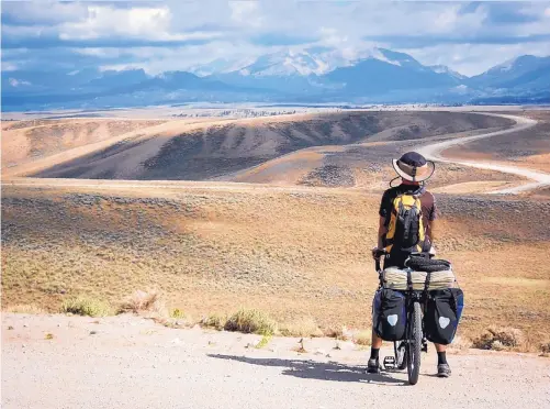  ?? COURTESY OF RUSS MCCOY ?? Russ McCoy looks out over the Great Divide Basin in Wyoming during his 2,768-mile trip on the Great Divide Mountain Bike Route from Banff, Canada, to Antelope Wells, N.M., in 2016.