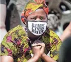  ?? RICK WOOD / MILWAUKEE JOURNAL SENTINEL ?? A woman listens intently to LaShawndra Vernon of Artists Working in Education as she speaks to protesters prior to their march on Juneteenth Day.