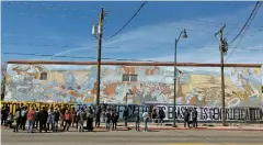  ?? LUIS SÁNCHEZ SATURNO/THE NEW MEXICAN ?? Demonstrat­ors in a Gentrifica­tion Walking Tour gather Saturday in front of the Multi-Cultural mural to support its preservati­on. Gilberto Guzman, who painted it in 1980, is suing to keep it from being torn down.