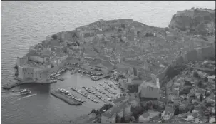  ?? The Associated Press ?? CROWDED: This Sept. 4 photo shows the old town of Dubrovnik from a hill above the city. Crowds of tourists are clogging the entrances into the ancient walled city, a UNESCO World Heritage Site, as huge cruise ships unload thousands more daily.