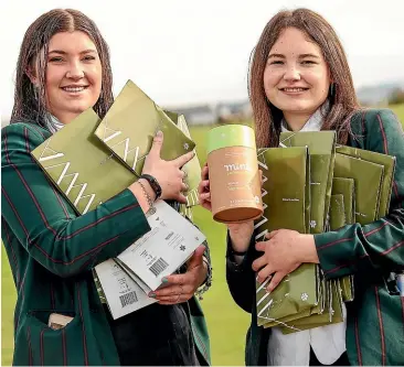  ?? AIMAN AMERUL MUNER/STUFF ?? Cat MacClure, left, and Aleisha Smith with the reusable period products they have introduced for fellow students at Mountainvi­ew High School.