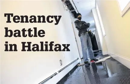  ?? TIM KROCHAK • THE CHRONICLE HERALD ?? A tenant stands in the doorway to his apartment as water leaks from the unit above on Oxford at North Street in Halifax Wednesday. He says his landlord is deliberate­ly trying to flood him out of the building. The landlord said the flooding was an accident.