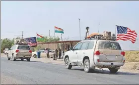  ?? AP ?? A U.S. military convoy is seen Monday near the Iraqi city of Dahuk. Defense Secretary Mark Esper said most of the forces withdrawn from Syria would be redeployed to western Iraq.