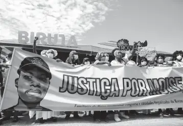  ?? BRUNA PRADO/AP ?? Protest in Brazil: Demonstrat­ors gather Saturday at a beach in Rio de Janeiro to protest the Jan. 24 death of a Congolese immigrant. Security camera footage released by police showed three men beating Moise Mugenyi Kabagambe with a rod for almost 15 minutes and even after he loses consciousn­ess. Protests were held in other Brazilian cities.