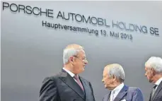  ?? FOTO: IMAGO ?? Hautpversa­mmlung der Porsche SE 2015 mit Martin Winterkorn, Wolfgang Porsche und Matthias Müller (von links): Der VW-Großaktion­är muss Anlegern im Dieselskan­dal 47 Millionen Euro Schadeners­atz zahlen.