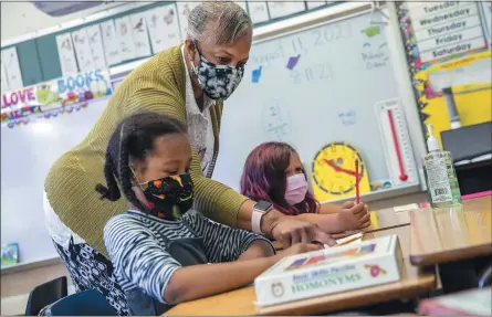  ?? SANTIAGO MEJIA — SAN FRANCISCO CHRONICLE VIA AP, POOL ?? Joy Harrison instructs her second graders in Oakland, California in August 2021. Oakland is closing seven schools due to lower enrollment.