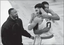  ?? ELISE AMENDOLA/AP PHOTO ?? Boston Celtics forward Jayson Tatum (0) celebrates with teammates Tristan Thompson, right, and Kemba Walker, left, after Friday night’s game against the San Antonio Spurs in Boston. Tatum scored 60 points to lead the Celtics to a 143-140 victory in overtime.