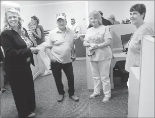  ?? Photo by Ernest A. Brown ?? Millville Town Administra­tor Jennifer Callahan, left, hosts an open house at the new Millville Town Hall, giving Millville residents Leonard and Beverly Ranslow, center, a first-hand look at the new place, with Treasurer/Tax Collector Lisa Larue,...