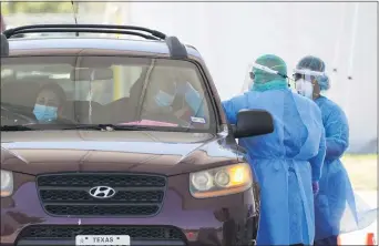  ?? ERIC GAY — THE ASSOCIATED PRESS ?? Medical personnel administer COVID-19 testing at a drive-through site, Friday, Aug. 14, 2020, in San Antonio.