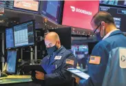  ?? Courtney Crow / New York Stock Exchange ?? Traders on the New York Stock Exchange watch DoorDash’s worth climb to $ 72 billion on its first day of trading as a public company Wednesday.