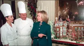  ?? (File Photo/AP/Wilfredo Lee) ?? First lady Hillary Clinton speaks with White House pastry chef Roland Mesnier and his assistant Franette McCulloch on Dec. 3, 1997, as she shows off their gingerbrea­d house creation during a press viewing of holiday decoration­s.