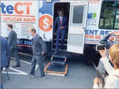  ?? Ken Dixon / Hearst Connecticu­t Media ?? Deputy Treasury Secretary Wally Adeyemo follows Gov. Ned Lamont after a tour of a tenant and landlord assistance vehicle parked at the senior center in Middletown on Thursday.