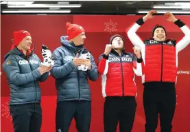  ??  ?? From left, driver Francesco Friedrich and Thorsten Margis of Germany and driver Justin Kripps and Alexander Kopacz of Canada celebrate after the two-man bobsled final Photo: AP