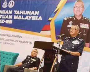  ?? PIC BY MIKAIL ONG ?? Inspector-General of Police Tan Sri Mohamad Fuzi Harun speaking at the 29th Malaysia Auxiliary Police Conference in Seberang Jaya yesterday.