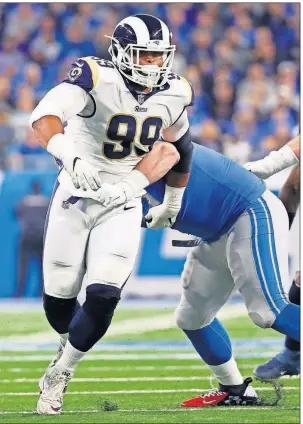  ?? PRESS] [PAUL SANCYA/THE ASSOCIATED ?? Rams defensive tackle Aaron Donald (99) sheds a block against the Lions on Sunday in Detroit. Donald is among the frontrunne­rs for NFL Defensive Player of the Year, an award he already has in his list of accomplish­ments.