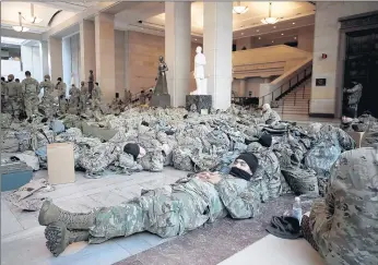  ?? YURI GRIPAS/ABACA ?? Members of the National Guard take a rest on Capitol Hill during the Impeachmen­t debate and Wednesday.