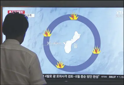  ?? AP PHOTO ?? A man watches a TV screen showing a local news program reporting on North Korea’s threats to strike Guam with ballistic missiles at the Seoul Train Station in Seoul, South Korea.