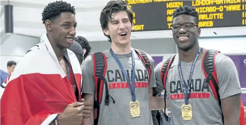  ?? CHRIS YOUNG/ THE CANADIAN PRESS FILES ?? R. J Barrett, left to right, Danilo Djuricic and Amidou Bamba arrive at Toronto’s Pearson Airport with other members of Canada’s under- 19 Basketball team after winning gold at the U19 FIBA World Cup, in Toronto on Monday, July 10, 2017. Canada’s...