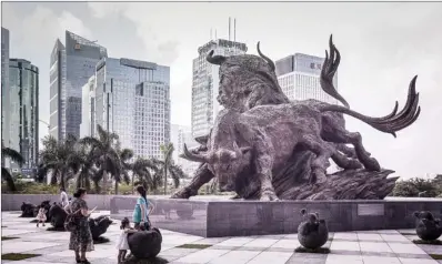  ?? QILAI SHEN / BLOOMBERG ?? Sculptures of bulls — symbolizin­g a red-hot stock market — front the entrance to the Shenzhen Stock Exchange building in Shenzhen. The Chinese mainland’s private equity sector saw strong growth last month, with total assets standing at 11 trillion yuan...