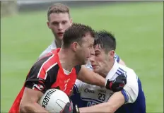  ??  ?? Niall Murphy (Bannow-Ballymitty) holds off Dylan Dalton (Ballyhogue) in their IFC Group A tie in Innovate Wexford Park on Saturday.