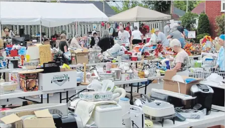  ?? SPECIAL TO THE EXAMINER ?? The much-anticipate­d annual Yard and Plant Sale at Grace United Church, to support their November building trip to Honduras, takes place Sept. 8. Shoppers, above, are shown looking for bargains at last year’s event.