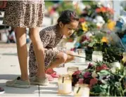  ?? DARIO LOPEZ-MILLS/AP ?? A child looks at a memorial Friday for the victims killed in this week’s shooting in Uvalde, Texas.