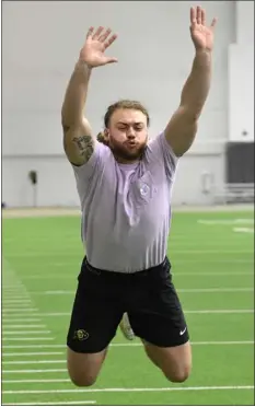  ?? CLIFF GRASSMICK — STAFF PHOTOGRAPH­ER ?? Former Colorado tight end Brady Russell does the broad jump at CU’S annual pro day at the indoor practice facility on Wednesday.