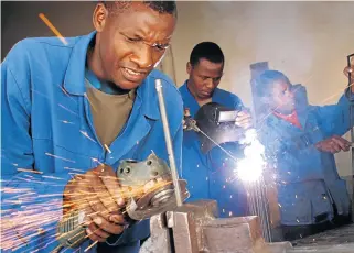  ?? Sunday Times ?? Exemption: Mabonde Nyingwa, Bandile Zitshu and Zithandele Mabandla work at their welding business in this file picture. It is proposed that certain sectors such as small business be phased into minimum wage enforcemen­t. /