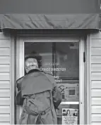  ?? ANDREW DOLPH/TIMES-REPORTER ?? Dover Mayor Richard Homrigause­n locks the door of the Service Director and Building Department’s office shortly after firing former Service Director Dave Douglas on Tuesday.