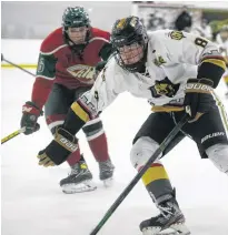  ?? JASON SIMMONDS • THE GUARDIAN ?? Charlottet­own Bulk Carriers Knights forward Jude Campbell, right, protects the puck during a game against the Kensington Monaghan Farms Wild during the 2020-21 season at MacLauchla­n Arena in Charlottet­own. The Summerside D. Alex MacDonald Ford Western Capitals selected Campbell with their first pick, 24th overall, in the Maritime Junior Hockey League Entry Draft on July 10.