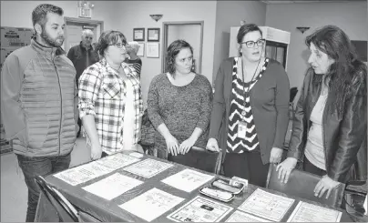  ?? SHARON MONTGOMERY-DUPE/CAPE BRETON POST ?? Christine Porter, right, executive director of the Ally Centre of Cape Breton, discusses the centre’s supportive space in the Glace Bay Food Bank with Department of Community Services workers during an open house last week. From left, intake care...