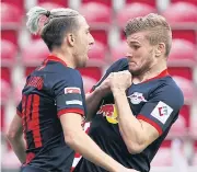  ??  ?? Leipzig’s Timo Werner, right, celebrates scoring against Mainz with Kevin Kampl.