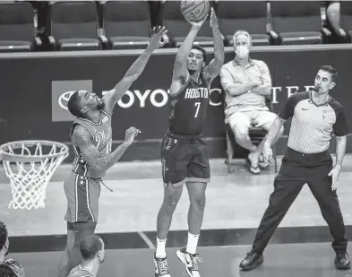  ?? Jon Shapley / Staff photograph­er ?? Rockets guard Armoni Brooks shoots while the 76ers’ Shake Milton defends Wednesday. Brooks came off the bench to score 20 points, including making six 3-pointers. He and fellow reserve Anthony Lamb combined for 42 points.