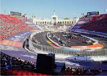  ?? Mark J. Terrill/Associated Press ?? Cars race during the qualifying portion of the 2023 Busch Light Clash NASCAR exhibition race at Los Angeles Memorial Coliseum.