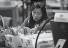  ?? Tribune News Service/los Angeles Times ?? An election worker verifies signatures on mail-in ballots on Sept. 14 the day of the recall election, at the Orange County Registrar in Santa Ana.