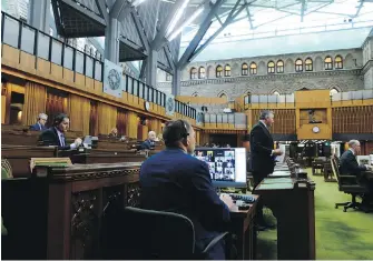  ??  ?? Members of Parliament are pictured on a computer screen as they take part via videoconfe­rence in the House of Commons on Parliament Hill in Ottawa on Wednesday.