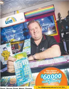  ?? Picture: LUKE BOWDEN ?? Dean Young from News Xpress Glenorchy hopes his customers can snag a winner.