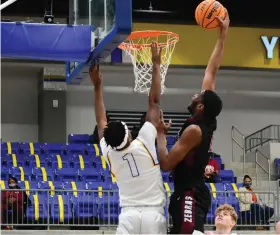  ?? (Pine Bluff Commercial/I.C. Murrell) ?? Jordon Harris of Pine Bluff throws down a one-handed dunk against Chris Crew of Sheridan on Saturday in Sheridan.