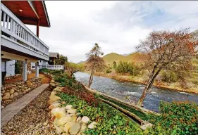  ??  ?? Expansive covered decks overlook the Kern River.