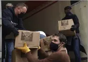  ??  ?? Volunteers unload boxes of food from a truck for a distributi­on program run through Mosaic West Queens Church in the Sunnyside neighborho­od of the Queens borough of New York on Feb. 22.