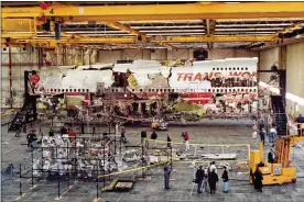  ?? THE NEW YORK TIMES 1997 ?? Wreckage recovered from TWA Flight 800 is assembled inside a hangar in Calverton, New York, on July 11, 1997. The National Transporta­tion Safety Board says it plans to decommissi­on and destroy the remaining wreckage.