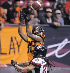  ??  ?? Lions wide received Shaq Johnson leaps for the ball while being pursued by Ottawa defensive back Sherrod Baltimore during Friday’s game.