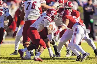  ?? VASHA HUNT/ASSOCIATED PRESS ?? New Mexico State’s O’Maury Samuels (5) looks for running room as Alabama defensive back Brian Branch (14) closes in during the second half of Saturday’s game in Tuscaloosa, Alabama.